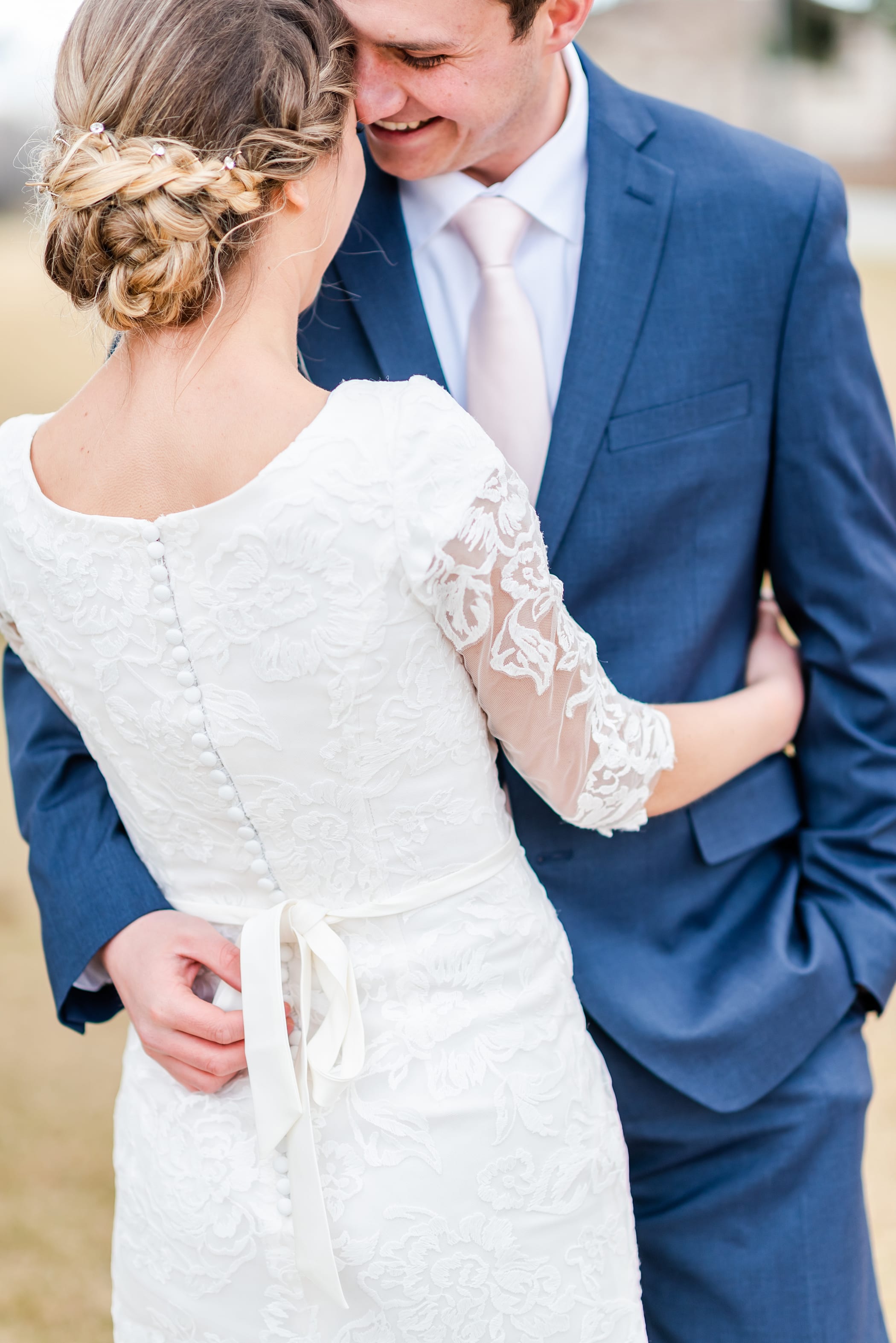 3/4 length lace sleeve wedding dress with navy suit