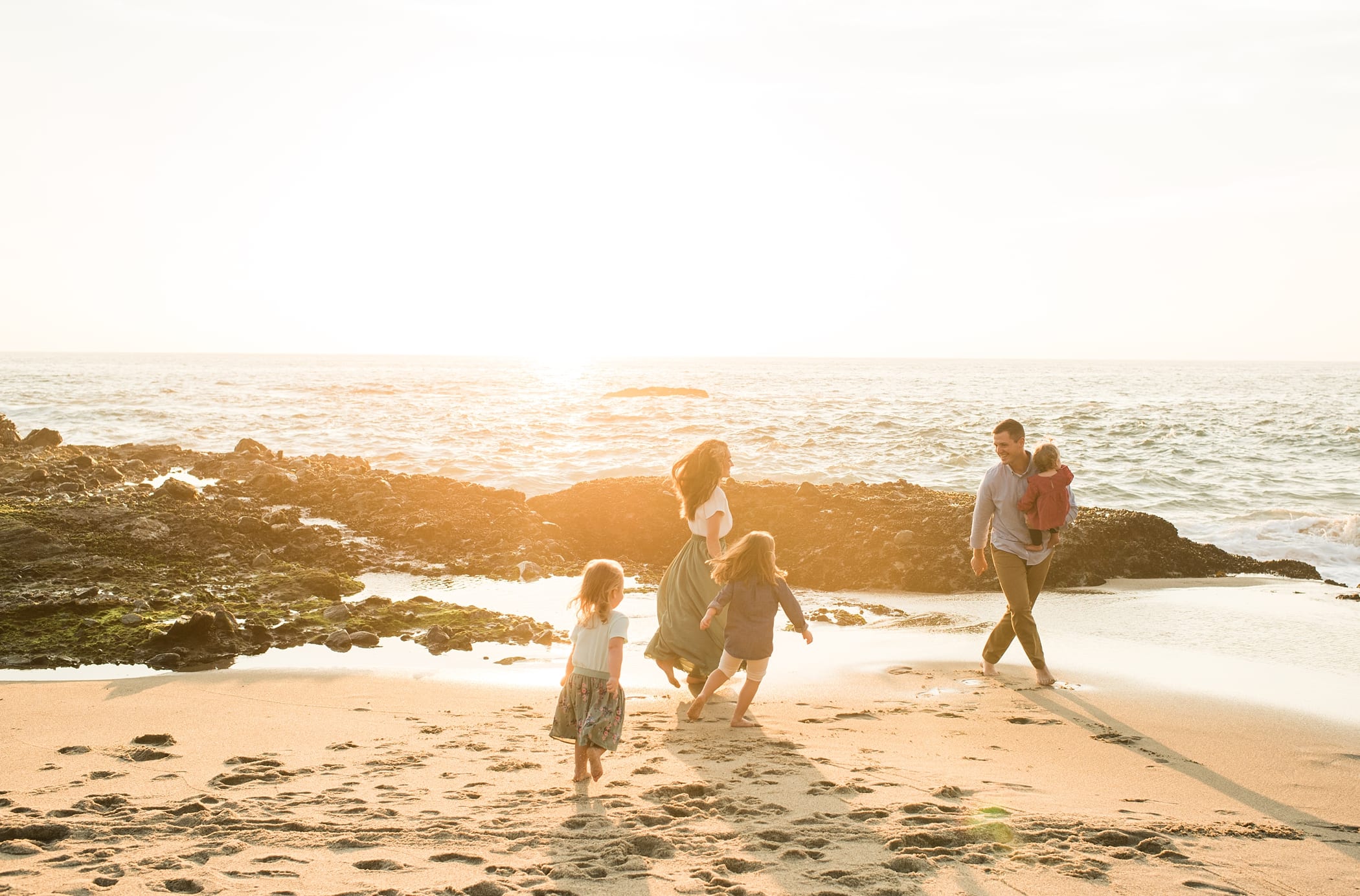 Playful sunset beach family photos in California at Laguna Beach
