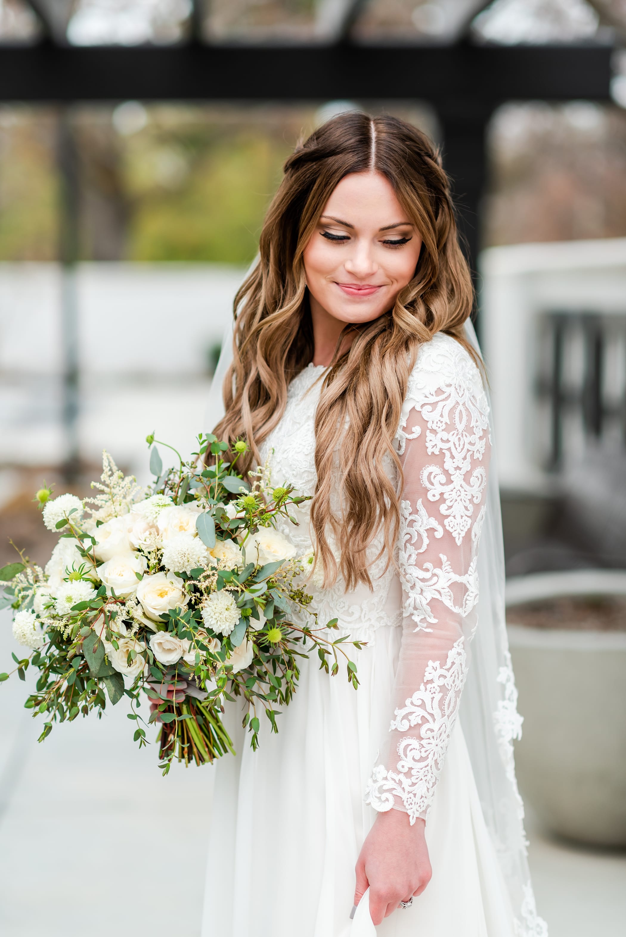 Bride with lace long sleeve wedding dress and Organic white and green bouquet for a spring wedding