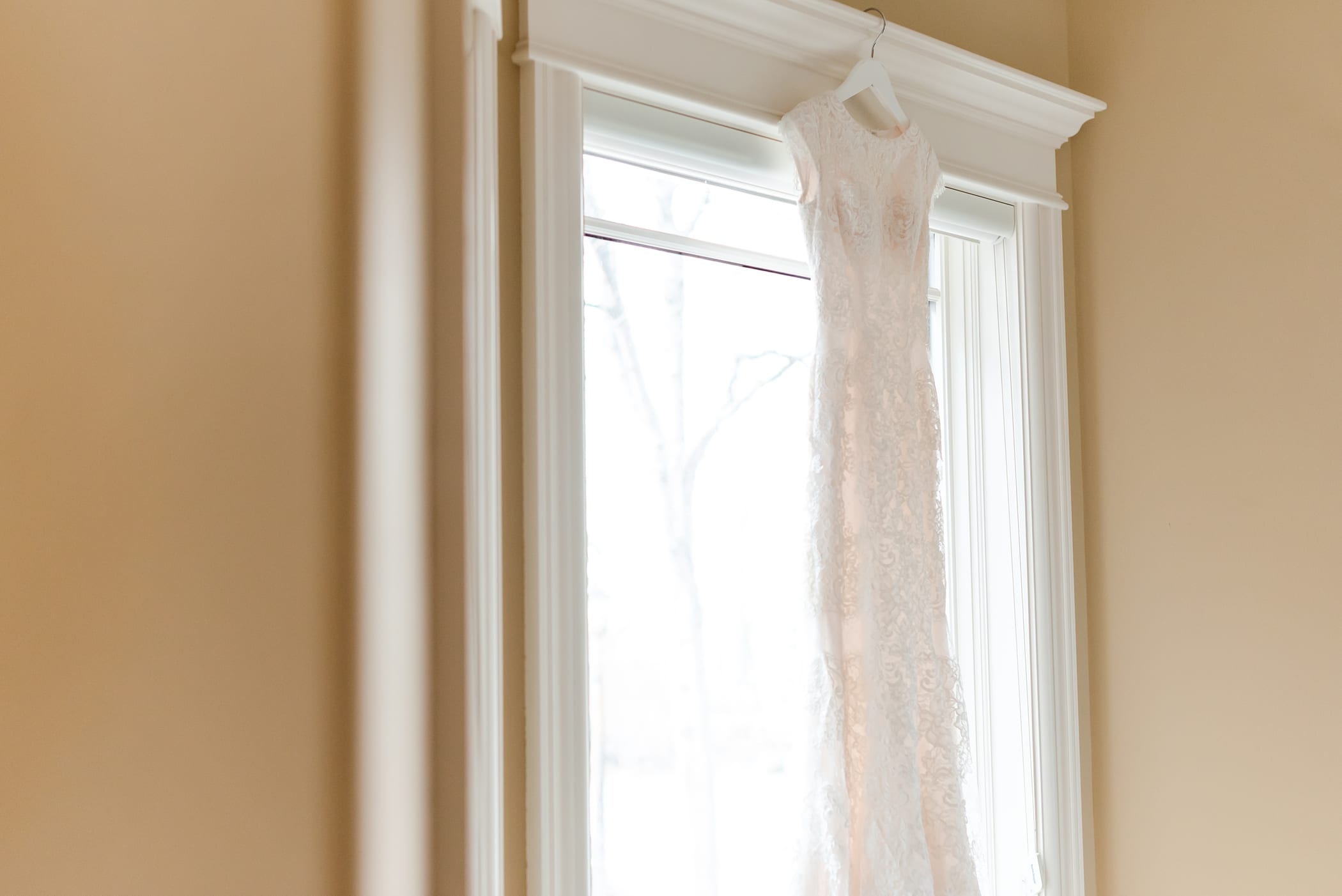 Wedding dress in window detail photo.